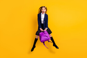 Full length body size view of her she small little cheerful amazed funky girlish girl jumping having fun after class new collection clothes isolated bright vivid shine vibrant yellow color background