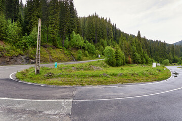 Asphalt road into misty mountains