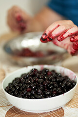 Man pitting wild cherries
