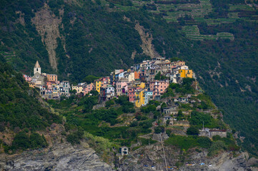 Obraz premium Corniglia, a Cinque Terra mountain village and tourist attraction on the steep coast of the Mediterranean sea in Liguria, Italy