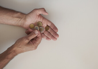 euro coins on man’s hand