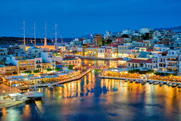 Beautiful Agios Nikolaos town on lake Voulismeni at night. Lasithi region of Crete island, Greece