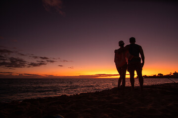 concept: romantic sunset as a pair in hawaii, perfect moment ,togetherness