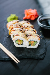 Sushi roll with eel on a slate plate