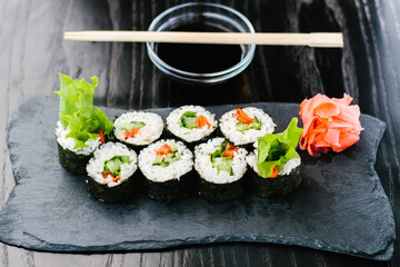 Maki roll with vegetables on a dark background