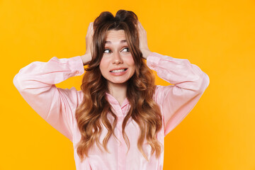 Image of beautiful confused woman grabbing her head and looking aside
