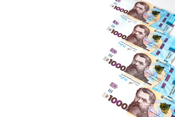 Ukrainian hryvnia, new banknotes of 1000 hryvnias on a white background, diagonal position, close-up, isolated. Money background, concept of gifts, shopping, space text. Ukraine