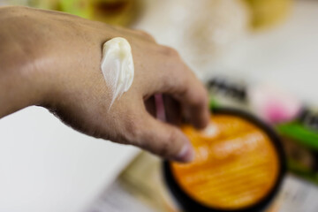 Woman moisturizing her hand with cosmetic cream. Close up view.