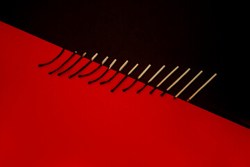 Different stages of match burning isolated on red and black background