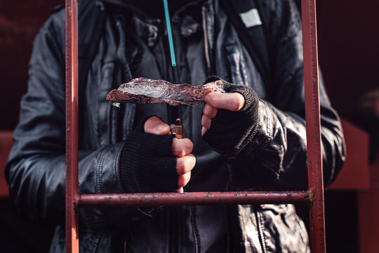 Drug Addict Smoking Opium On Tin Foil