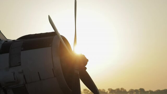 Propeller of an old plane in the rays of dawn