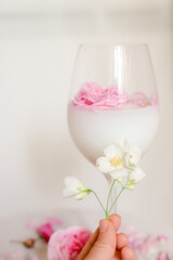 Glass with milk and roses on the table