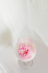 Glass with milk and roses on the table