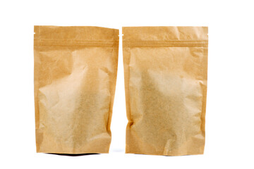 Two brown paper packets on a white background