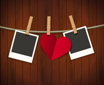 Two photo frames and heart for valentines day hanging on rope on the wood background. Vector illustration. EPS 10.