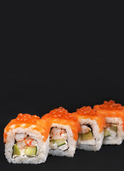 Japanese rolls on black stone background.