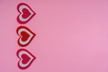 Vertical red hearts on a pink background. Conceptual photo. Copy space.