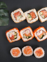 Japanese rolls on black stone background.