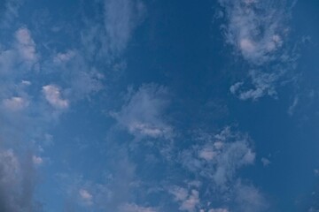 Evening sky in the mountains. Pink clouds from sunset float overhead.