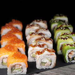 Japanese rolls on black stone background.