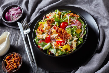 chicken club salad in a black bowl