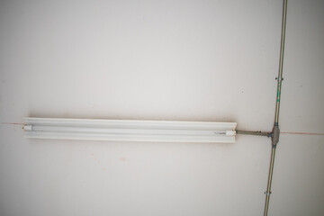 empty white wall with light and power line 