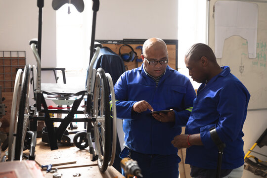 Multi races workers talking about wheelchairs