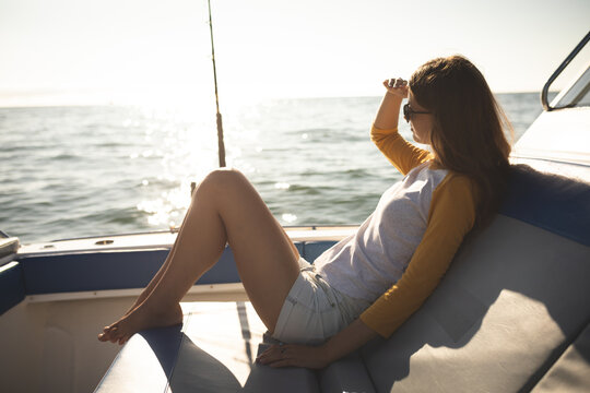 A teenage Caucasian girl enjoying her time on a boat