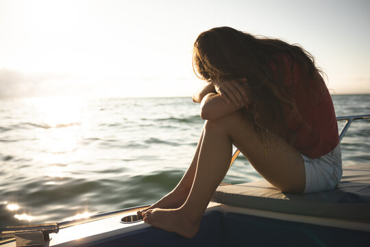 A teenage Caucasian girl enjoying her time on a boat