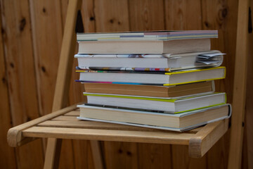 stack of books on wooden chair