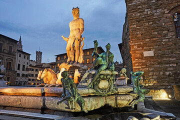 Statue of Neptune illuminated at night in Piazza della Signoria in Florence