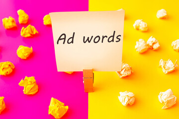Ad words text on papercrumpled paper wads with a sheet of white and yellow paper