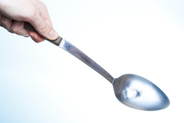 Man holding a soap ladle. Man in the kichen concept.