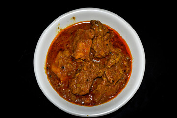 South Indian cuisine Kerala Style Beef curry / roast. Traditional style meat curry on Black background. Indian spicy curry. Selective focus photograph.