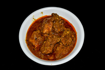 South Indian cuisine Kerala Style Beef curry / roast. Traditional style meat curry on Black background. Indian spicy curry. Selective focus photograph.