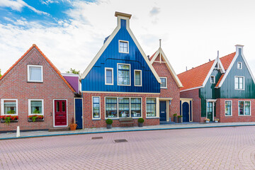 Old streets in Volendam, old traditional fishing village, typical wooden houses architecture