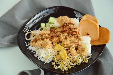 Ketoprak, vegetarian Indonesian food from Indonesia. consists of tofu, cucumber, rice cake, rice vermicelli and mung bean sprouts served with peanut sauce, soy sauce, kerupuk and fried shallot