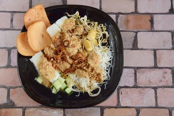 Ketoprak, vegetarian Indonesian food from Indonesia. consists of tofu, cucumber, rice cake, rice vermicelli and mung bean sprouts served with peanut sauce, soy sauce, kerupuk and fried shallot