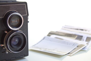 Old photo camera with negatives and photos taken