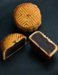 Moon cakes cut by mid autumn festival are placed on a black backgroundMoon cakes cut by mid autumn festival are placed on a black background