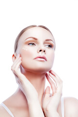 Beauty portrait of young woman with healthy perfect skin, apply cream on face, beautiful hands. Isolated, white background