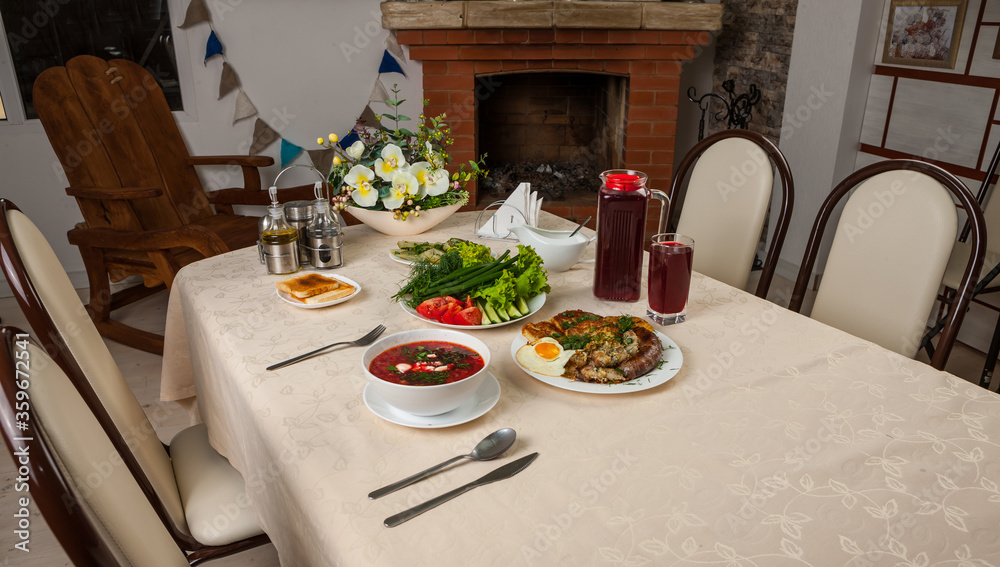 Wall mural russian lunch with red borsch, fried egg, fried sausage, bacon and potato pancakes. closeup photo of