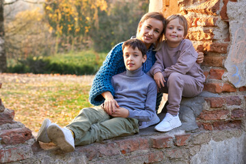 happy family mother and two boys on autumn walk