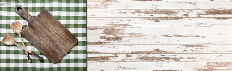Empty cutting board and tablecloth on wooden deck table with napkin