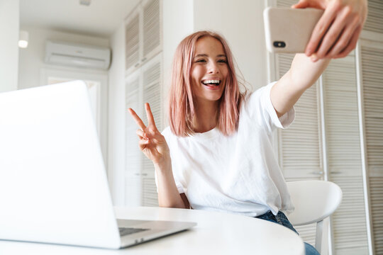 Cheerful young girl using laptop computer