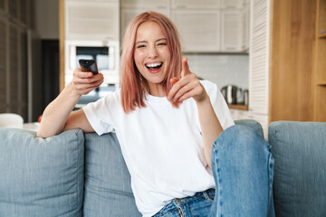 Lovely young attractive woman relaxing on a couch