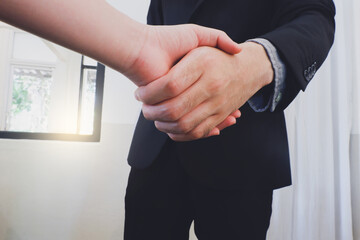 Close up image of business partners shaking hands.