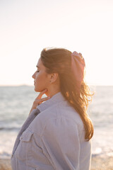 Fototapeta na wymiar Young beautiful woman posing on summer beach.