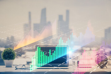 Forex graph hologram on table with computer background. Multi exposure. Concept of financial markets.