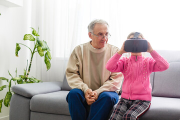 Obraz premium Senior man and his granddaughter playing video games